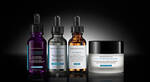 Dos frascos de suero de SkinCeuticals: H.A. Intensifier y C E Ferulic, con cuentagotas, sobre fondo blanco.