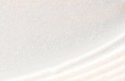 Close-up of a smooth, white surface with a subtle shimmer, featuring gentle curves and a textured edge.