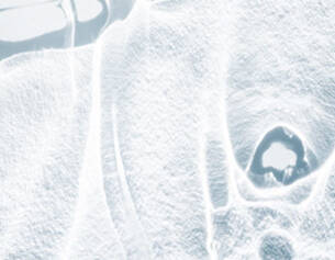 Abstract ice texture with smooth, reflective surfaces and intricate patterns, creating a cold, serene atmosphere.