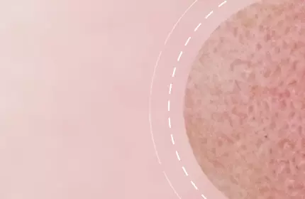 A close-up of a textured circular object set against a soft pink background, with dashed lines creating a circular pattern around it.