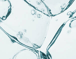 Close-up of clear water bubbles and ice cubes, creating a refreshing, frosty atmosphere.