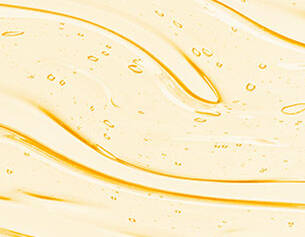 Swirling golden liquid with bubbles, creating a smooth, wavy texture.
