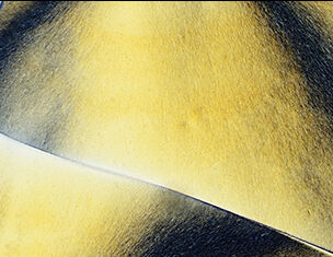 Close-up of textured, yellow and black abstract surface, showcasing smooth curves and gradients.