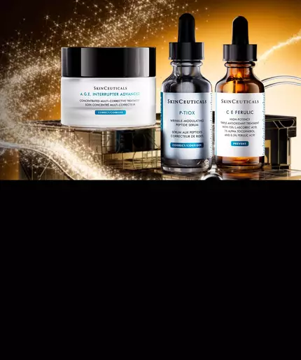 A close-up shot of two SkinCeuticals serum bottles, A.G.E Interrupter Ultra Serum and P-Tiox, standing in front of a dark gift box with a sparkling gold ribbon.